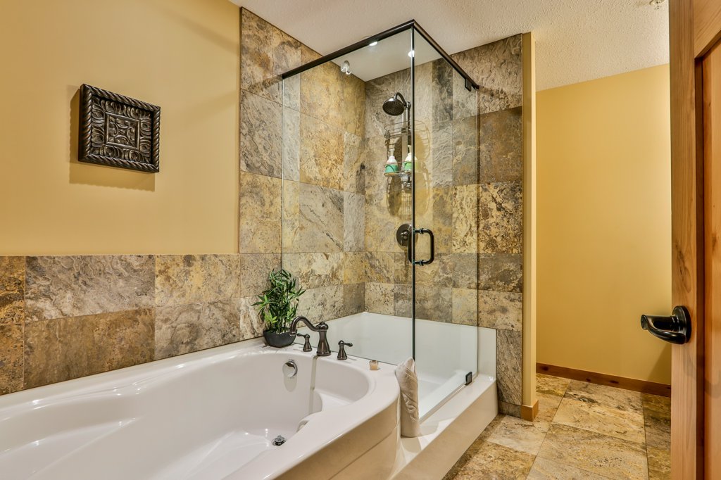 bathroom with bathtub and shower in #310 Rundle Cliffs Lodge