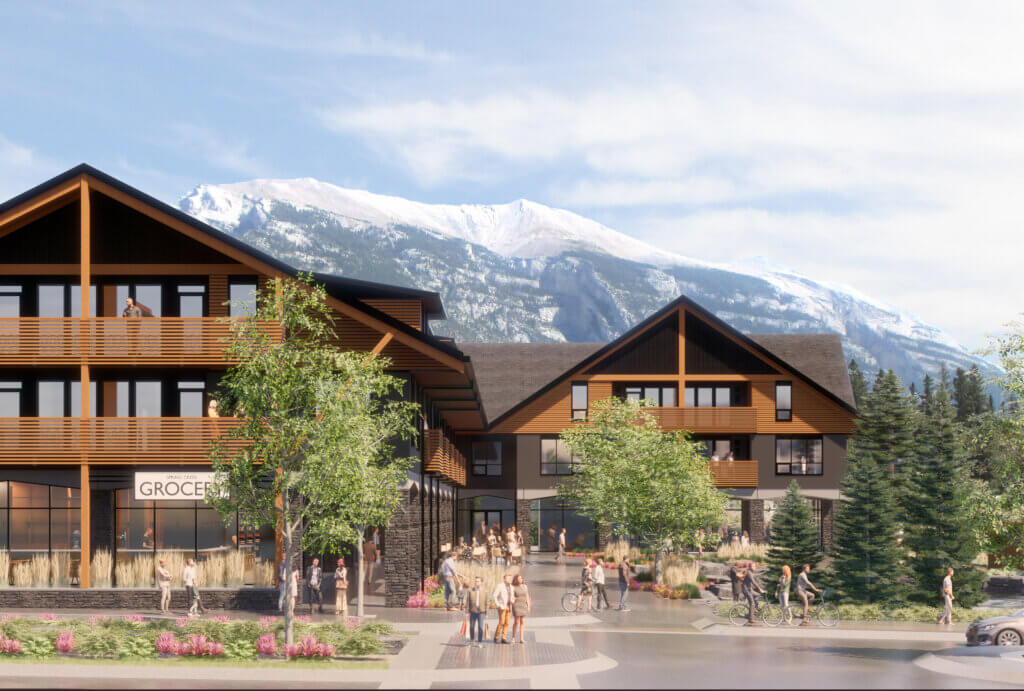 A rendered view of the front of the Tamarack Lodge, with lush gardens and a view of the mountains in the background.