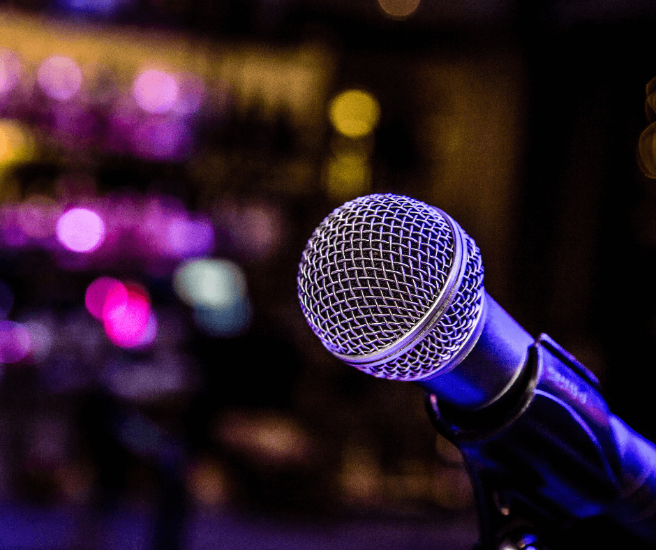 A microphone on a stand in a low-lit bar for a Friday Night Comedy, a fun activity in Canmore in the winter.